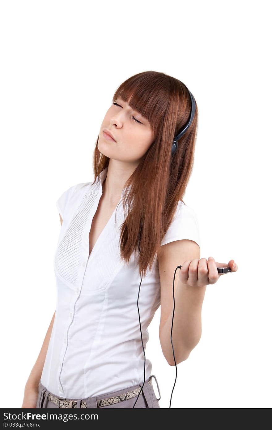 The beautiful girl listens to music in ear-phones. The beautiful girl listens to music in ear-phones