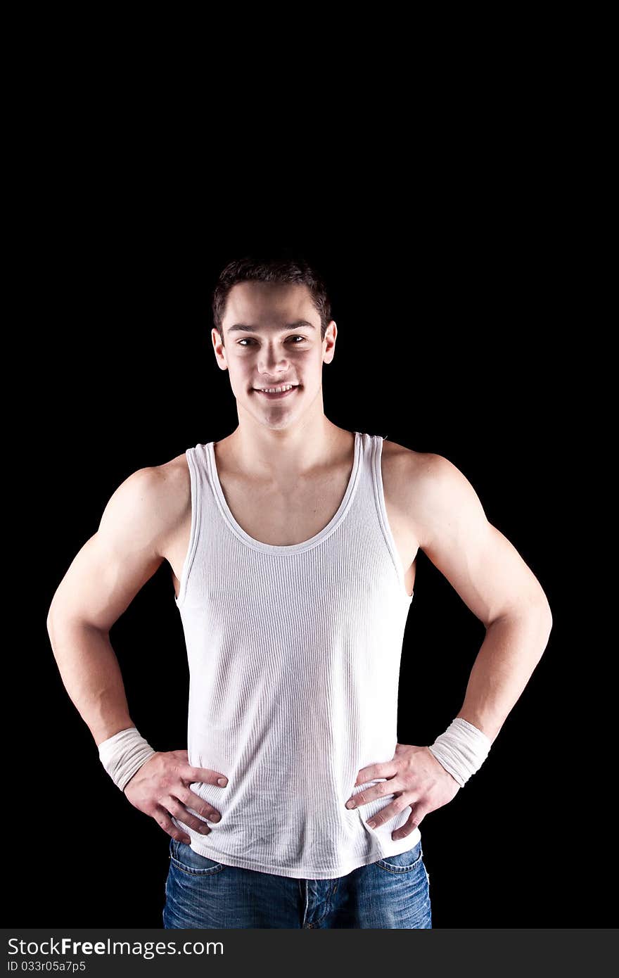 Young, fresh and strong man isolated over black background. Young, fresh and strong man isolated over black background.