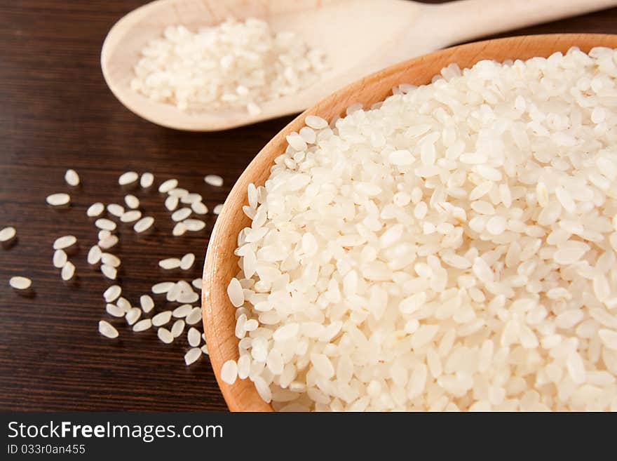 Rice and wood plate with spoon on table