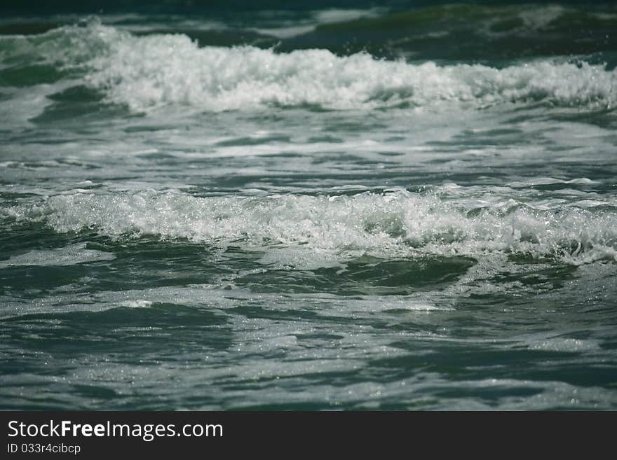 Waves coming to the shore in a hot summer day. Waves coming to the shore in a hot summer day