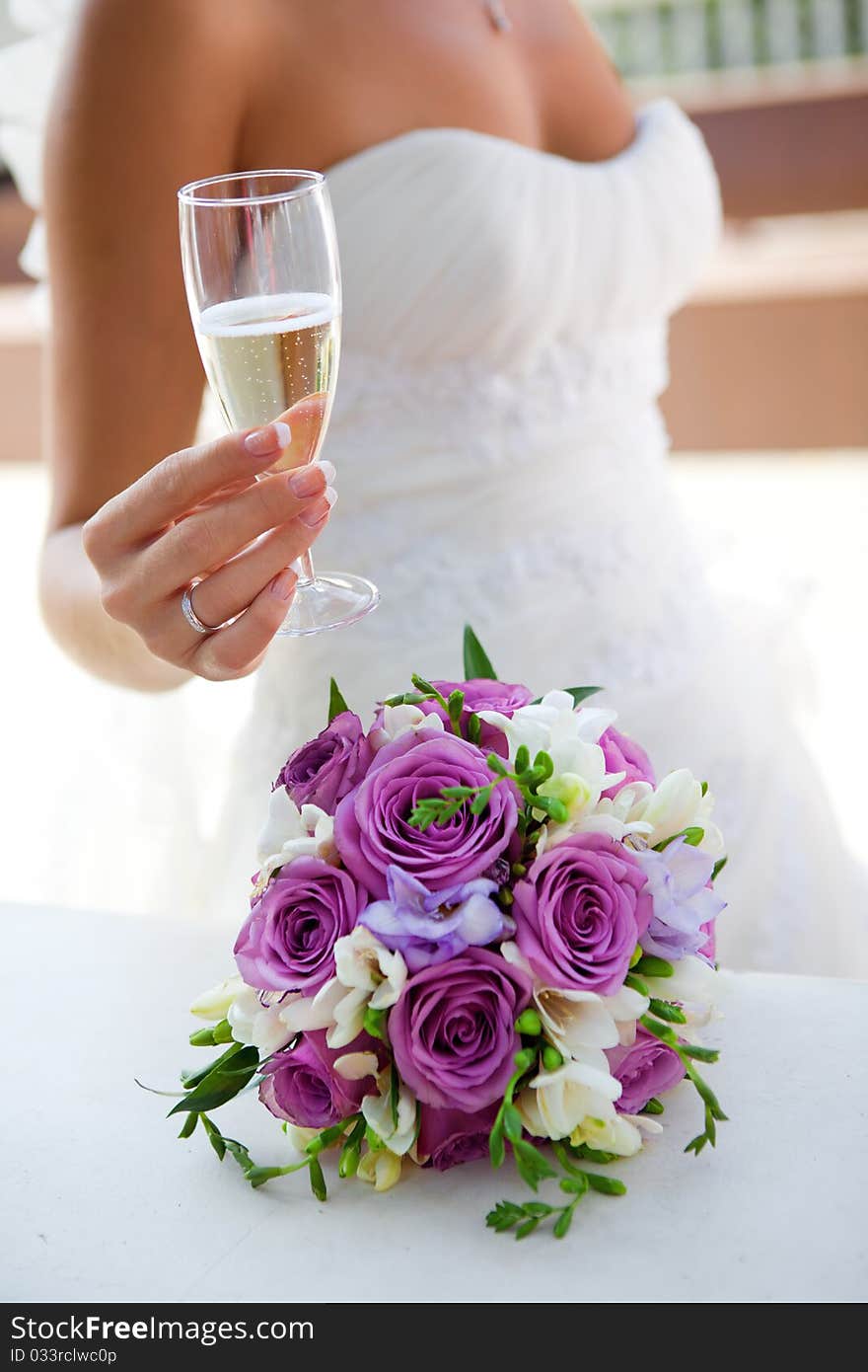 Glass of champagne in a hand of a bride