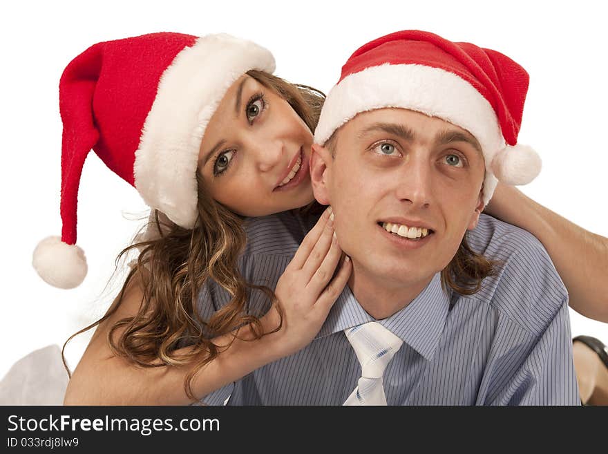 Young woman whispering in boyfriend`s ear. Isolated over white background