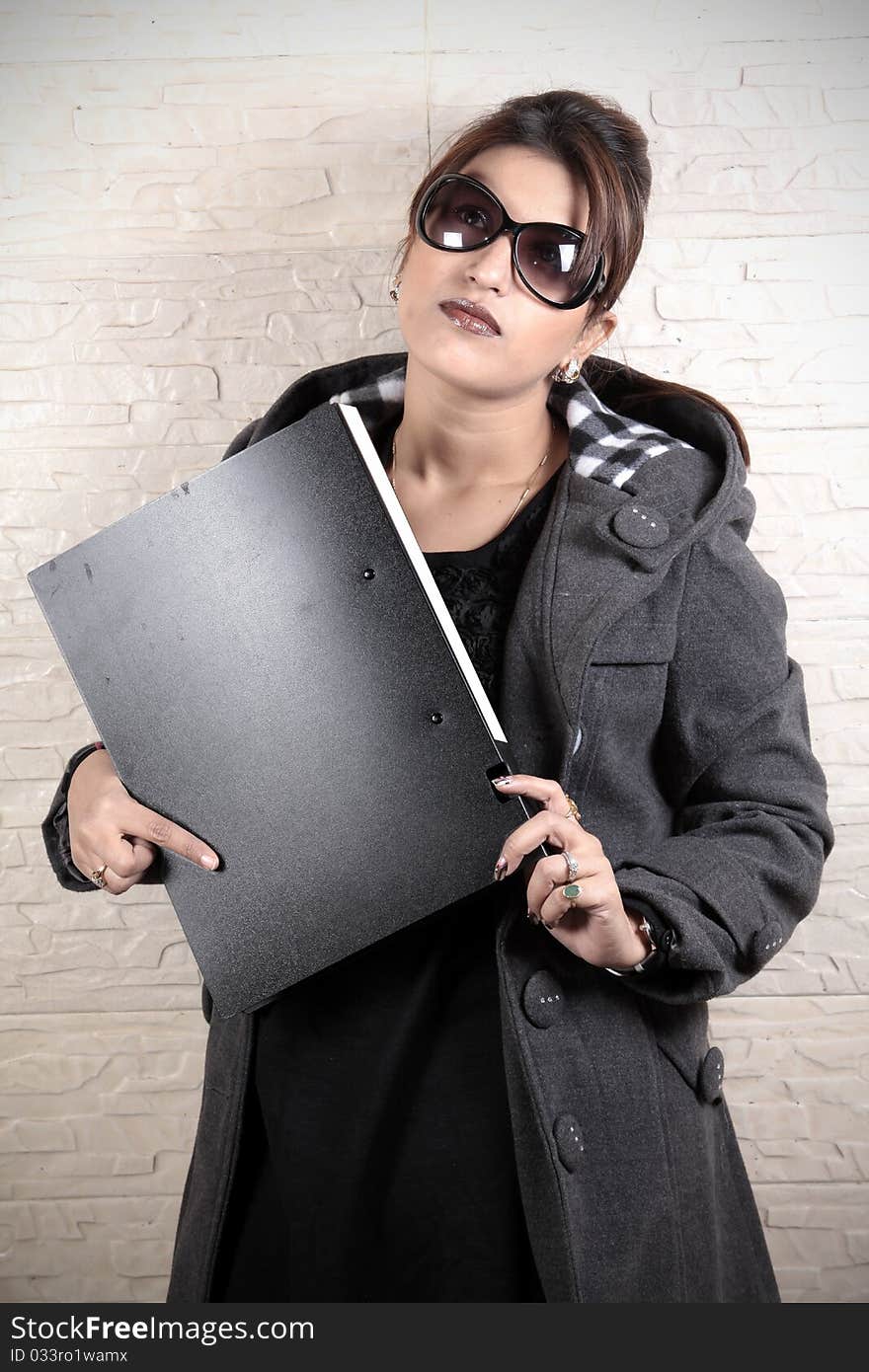 Office secretary holding black file.