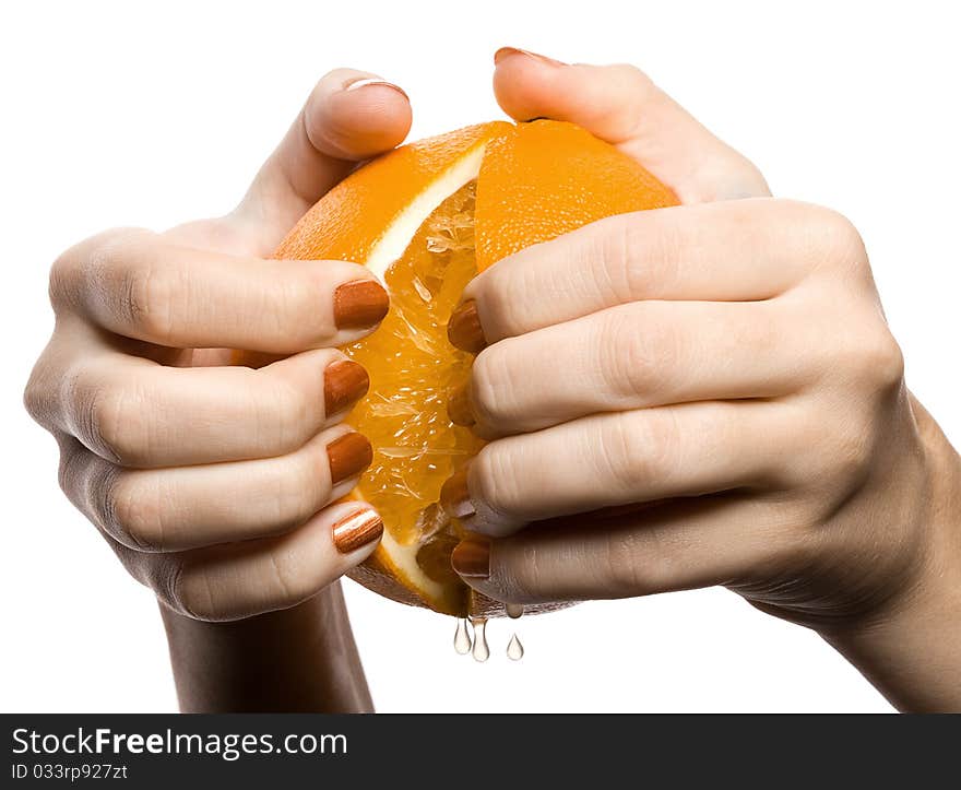 Two hands break off an orange on a part, is isolated on the white. Two hands break off an orange on a part, is isolated on the white