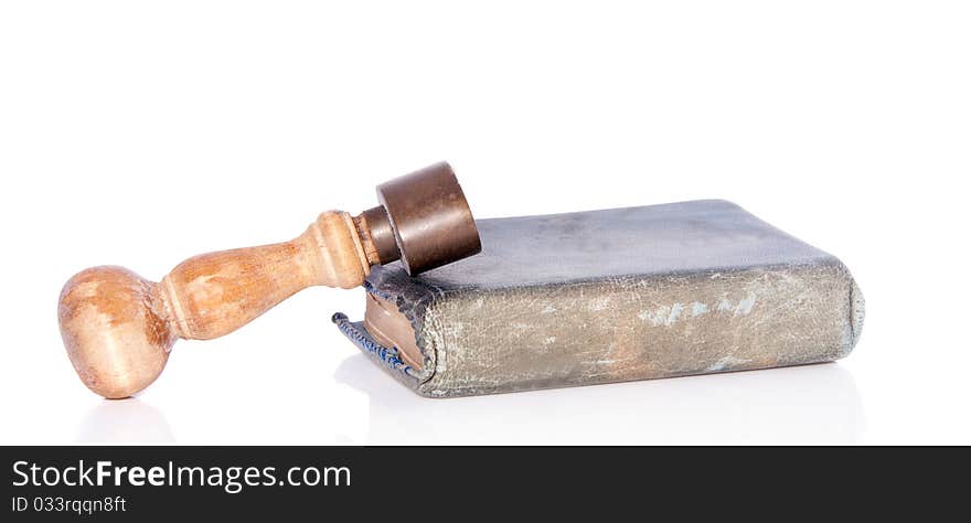 An old stamp on an old book isolated on white background