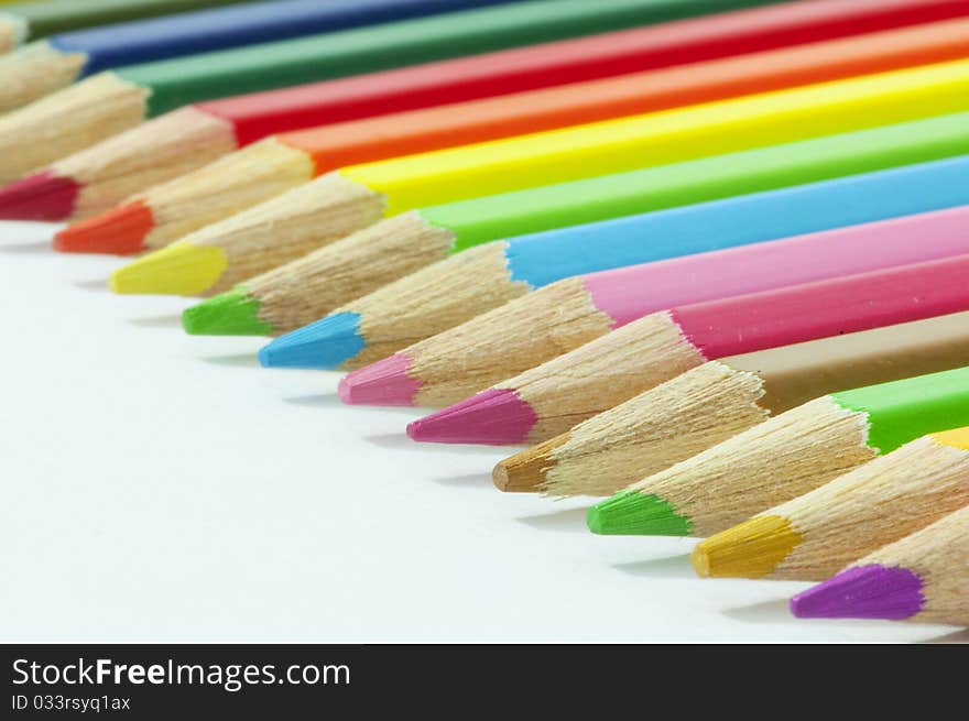 Colored pencils arranged in rainbow's colors