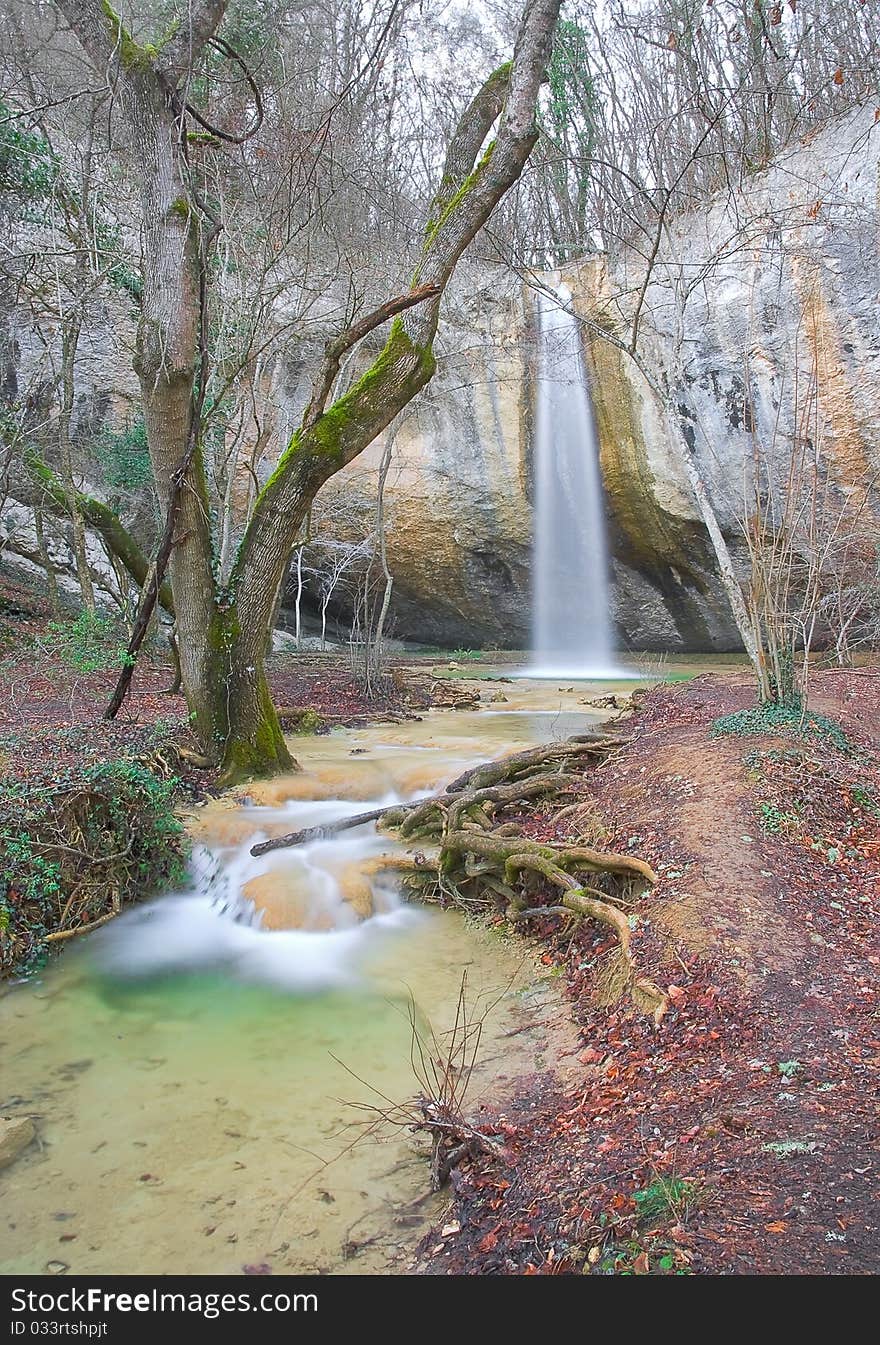 Waterfall and stream in the forest in autumn. Waterfall and stream in the forest in autumn.