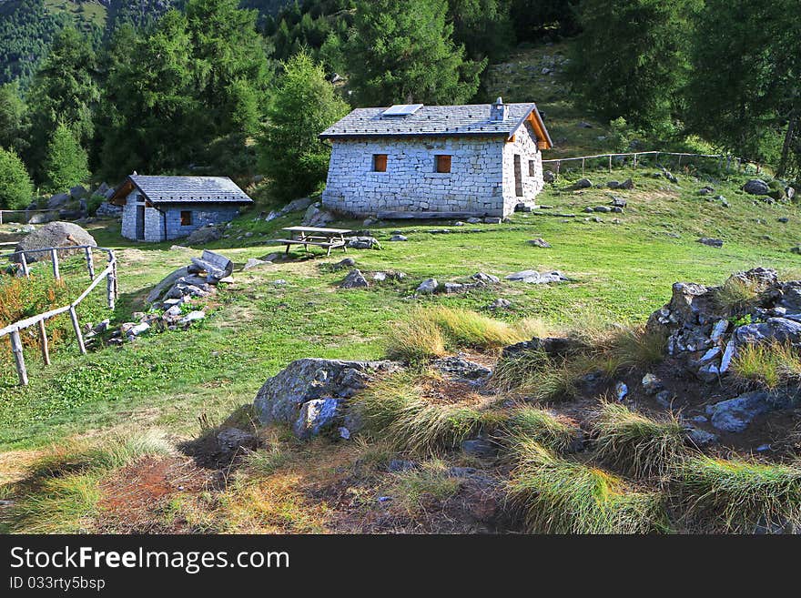 Cabins in a mountain valley in the North of Italy. Brixia province, Lombardy region, Italy