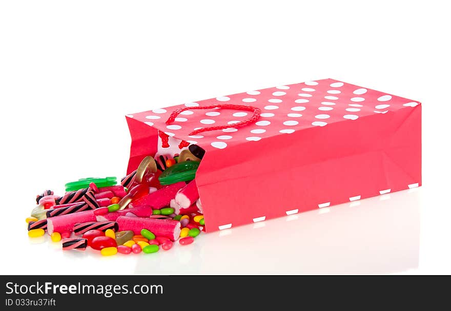 Colorful delicious candy in a fallen bag isolated over white