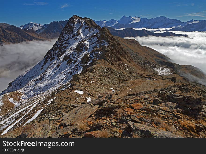 Graole Peak at 2861 meters on the sea-level. Brixia province, Lombardy region, Italy. Under, a sea of fog