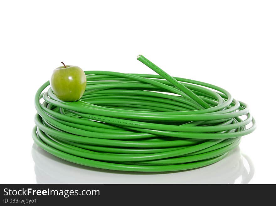 Green apple on top of an energy cable  isolated over white. Green apple on top of an energy cable  isolated over white