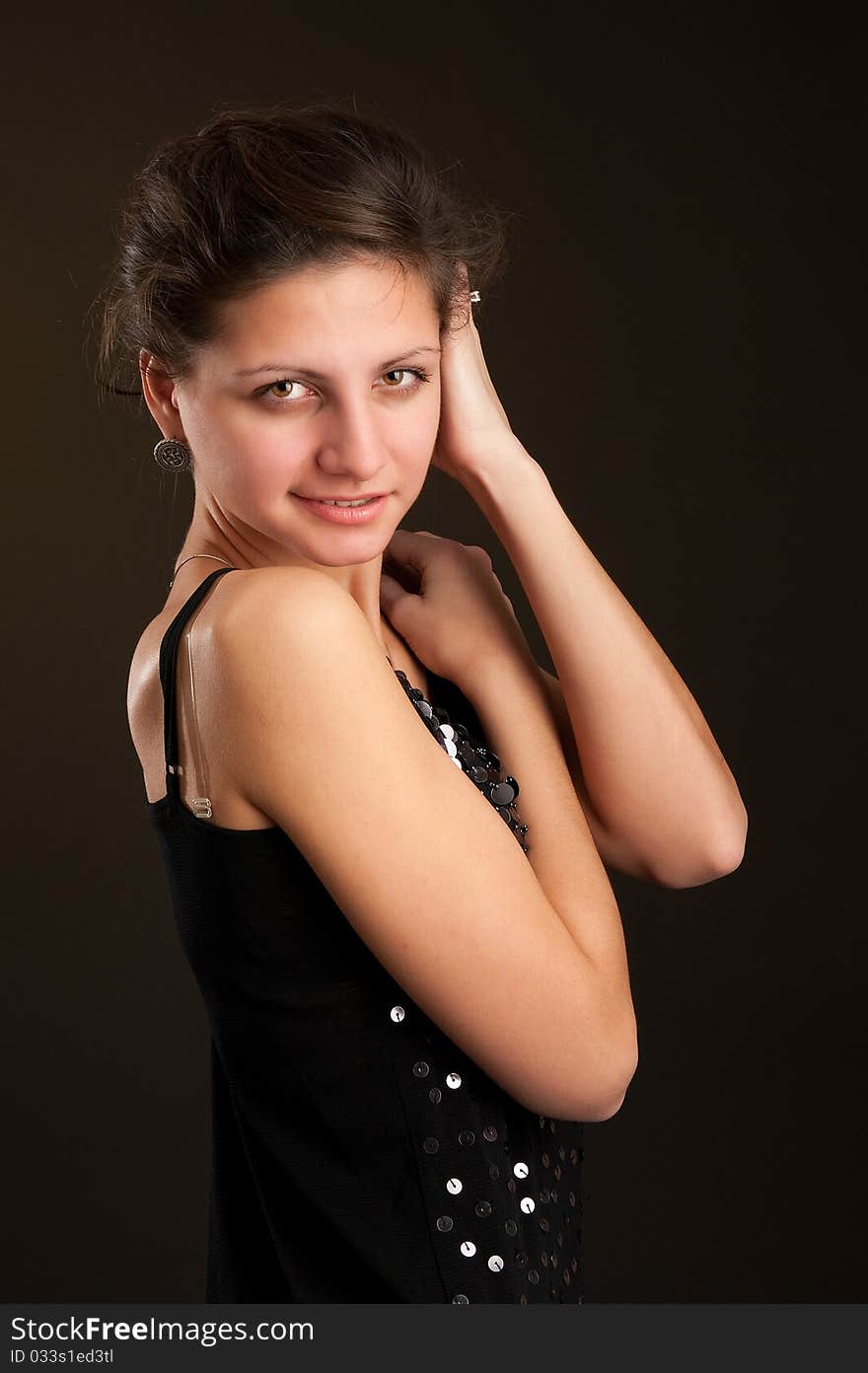 Portrait of young woman. Dark background