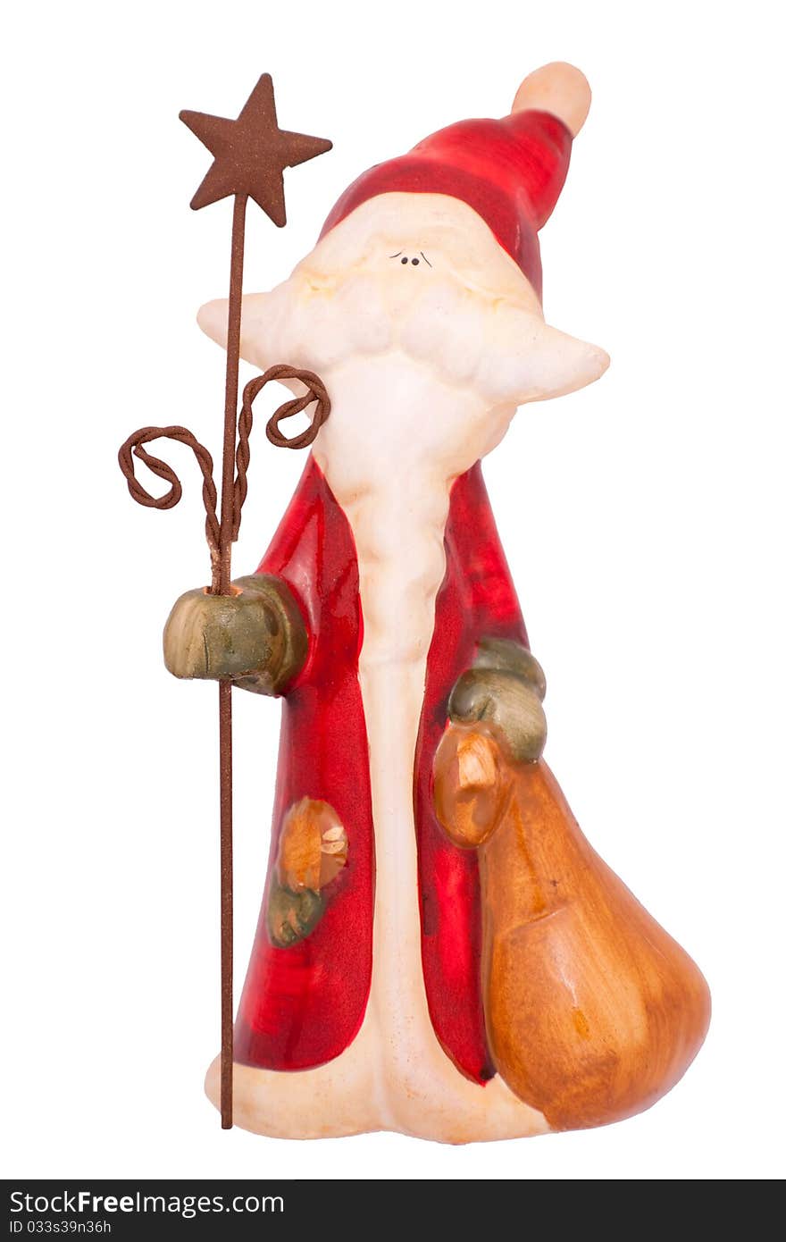 Isolated colored ceramic Santa with bag and staff