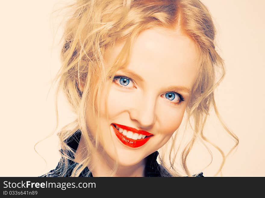 Portrait of a blond lady with a beautiful hair and red lips