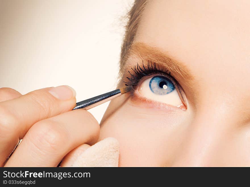 Charming Young Woman Applying Blusher Eyelid