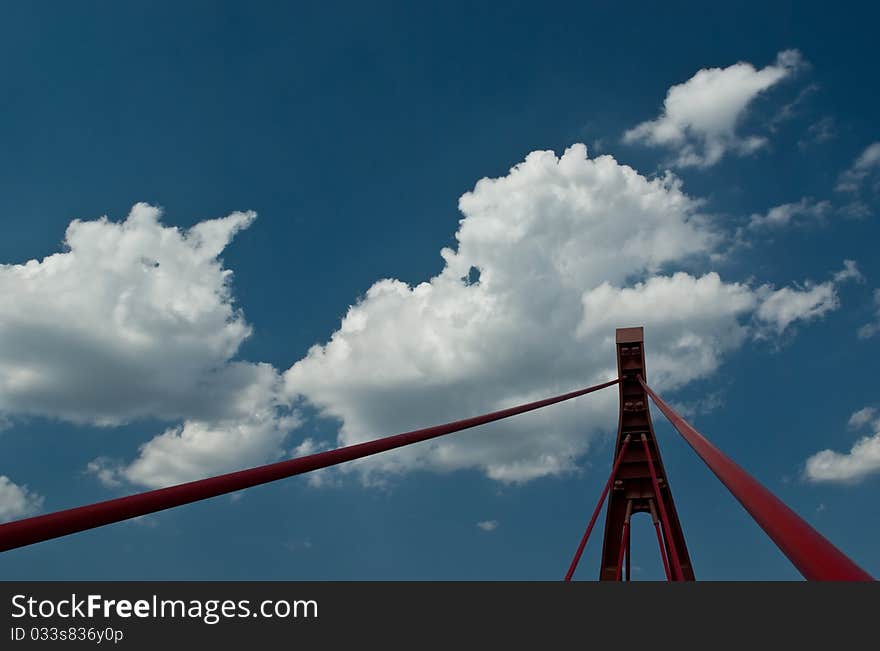 Bridge pylon with cables against the cloudy sky.