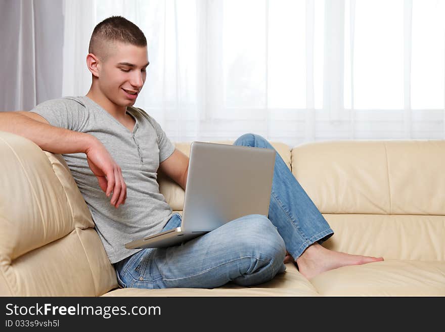 Handsome Man Using His Laptop At Home