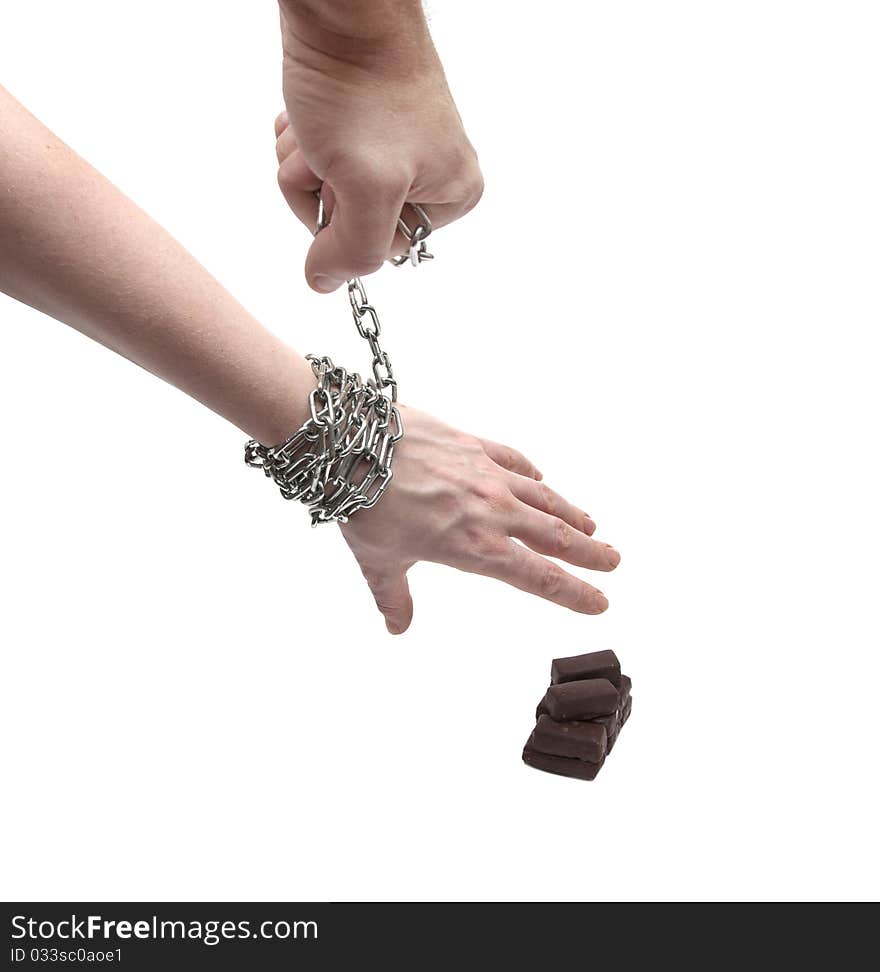 Woman s hand in chains reaching for candy