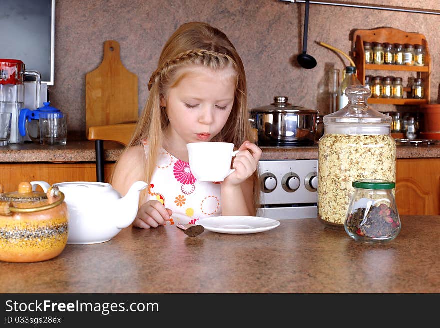 Girl Blowing To Cup Of Hot Drink