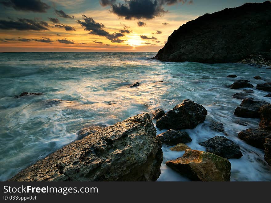 Beautiful seascape. Sea and rock at the sunset. Nature composition.