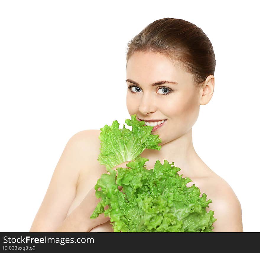 Beautiful young female face with sald leaves isolated on white. Beautiful young female face with sald leaves isolated on white