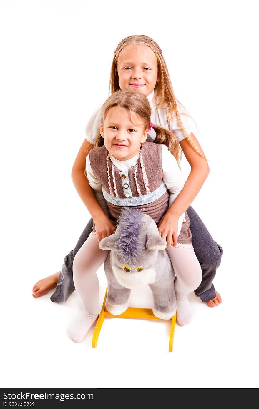 Two girls with a toy on a white background