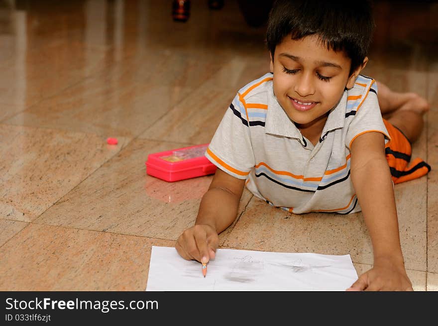 An Handsome Indian boy doing his artwork. An Handsome Indian boy doing his artwork