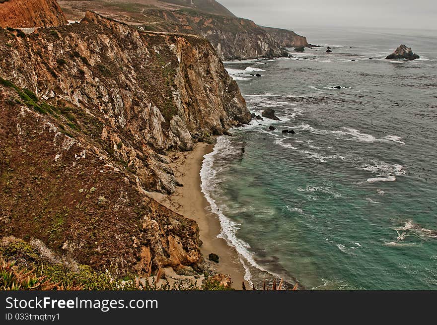 Waves hitting the rugged coastline in Big Sur California