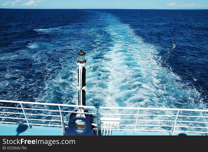 Streaming blue water surface, seen from a ship