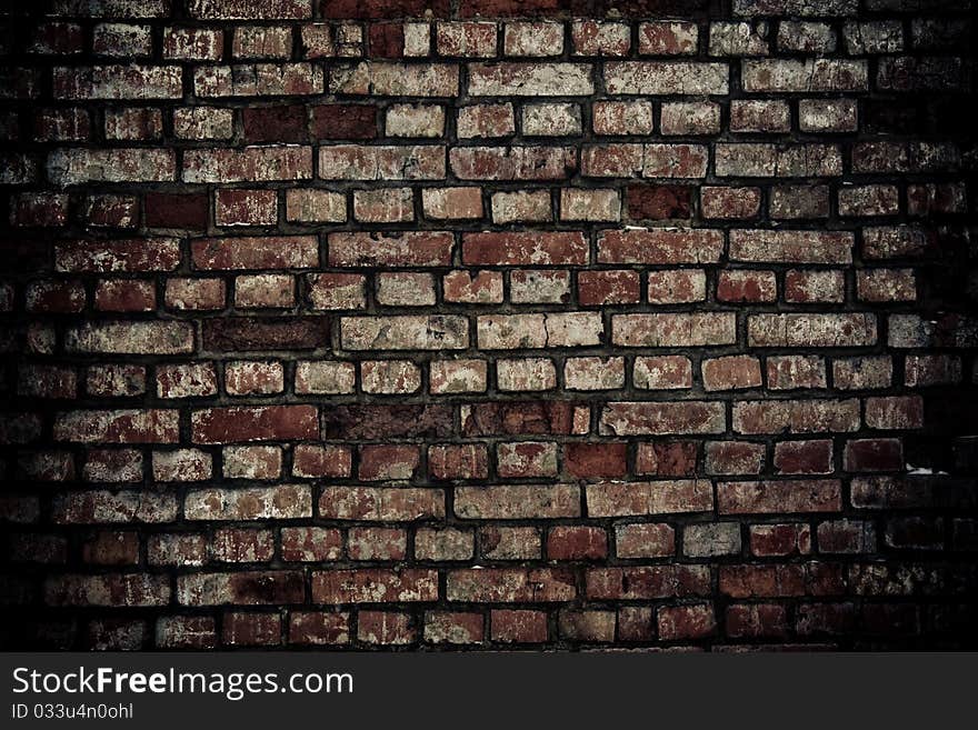 Dilapidated brick wall with remnants of plaster. Dilapidated brick wall with remnants of plaster