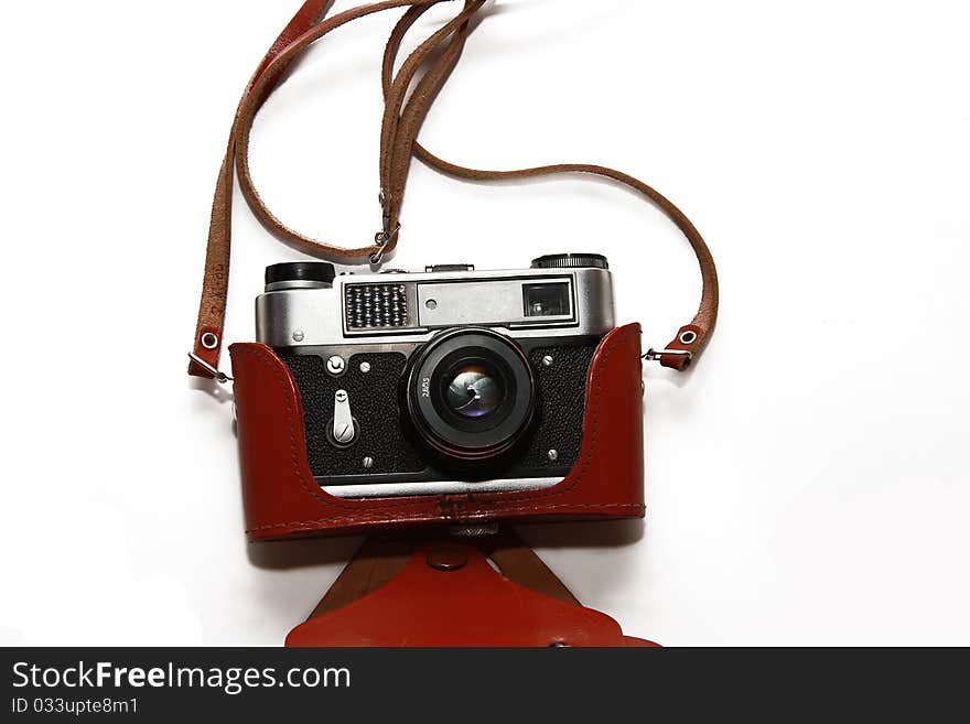 The Soviet film camera in a brown leather case  isolated on white. The Soviet film camera in a brown leather case  isolated on white