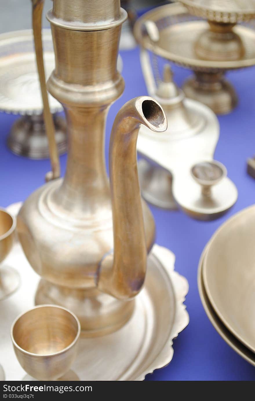 The shiny brassware and a kettle with a spout