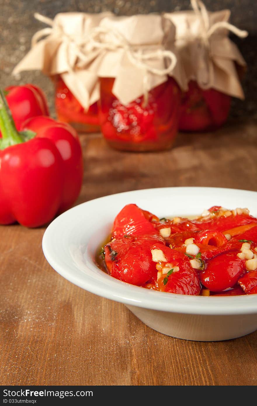 Snack from red paprika in olive oil and fresh red paprika