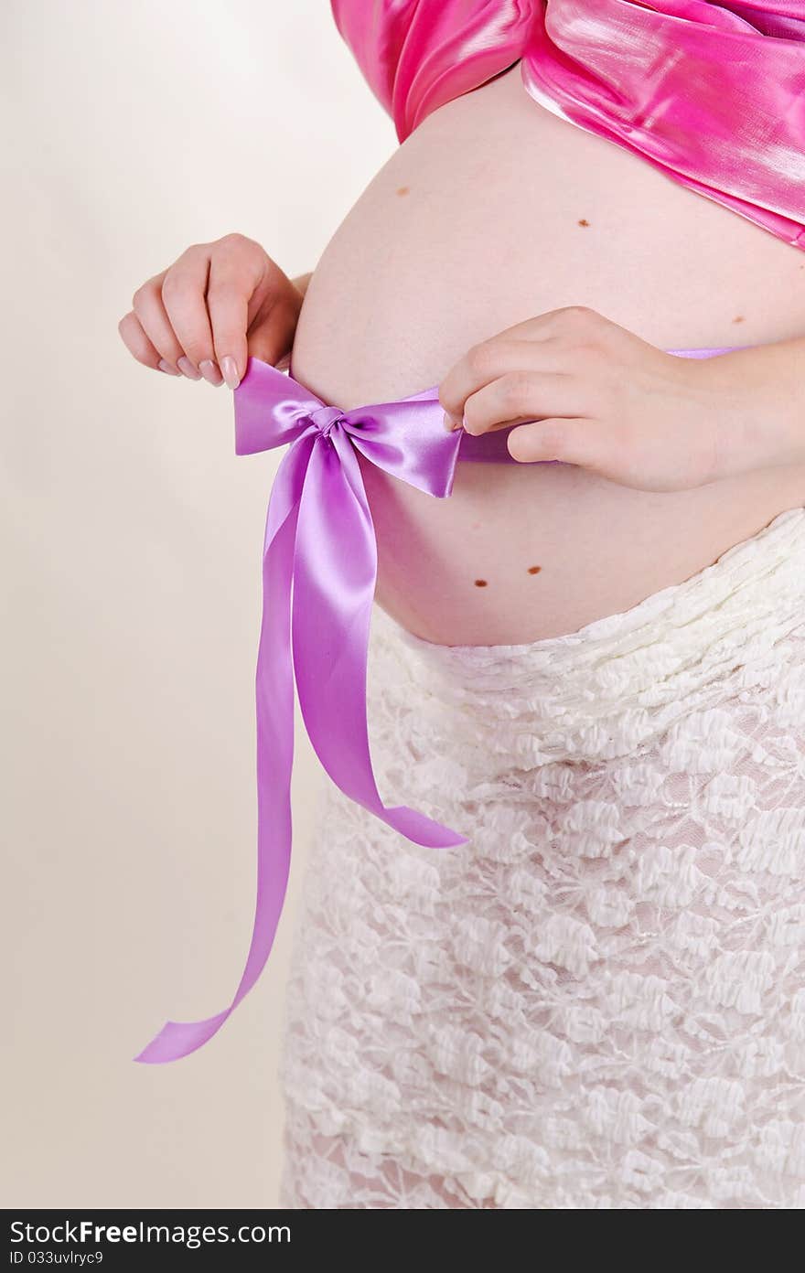 Isolated pregnant woman with a violet bow