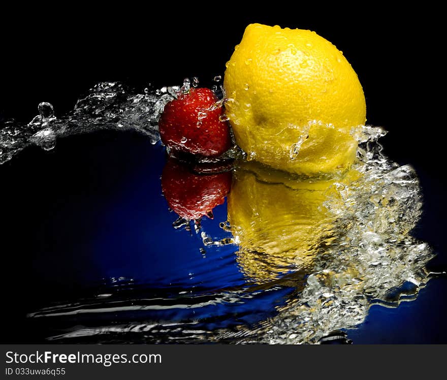 Lemon and strawberry with splashes of water. Lemon and strawberry with splashes of water