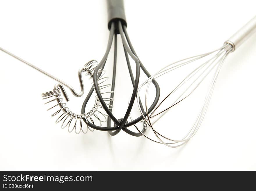 Whisk of metal and plastic onto white background