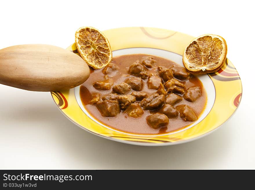 Goulash soup with wooden spoon