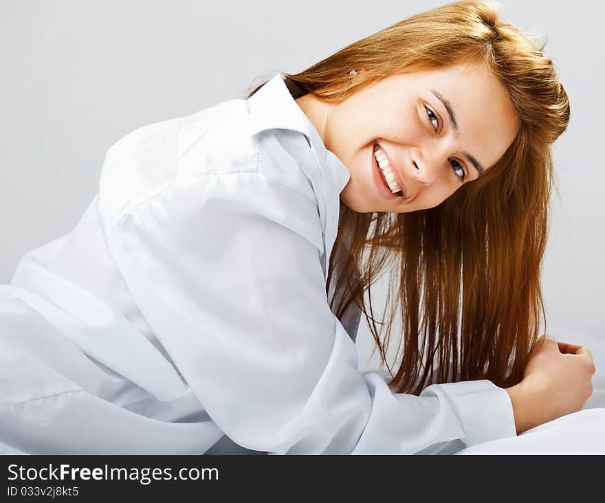 Smiling young woman lying on the floor