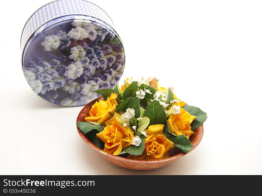 Bunch of flowers in bowl with tin can