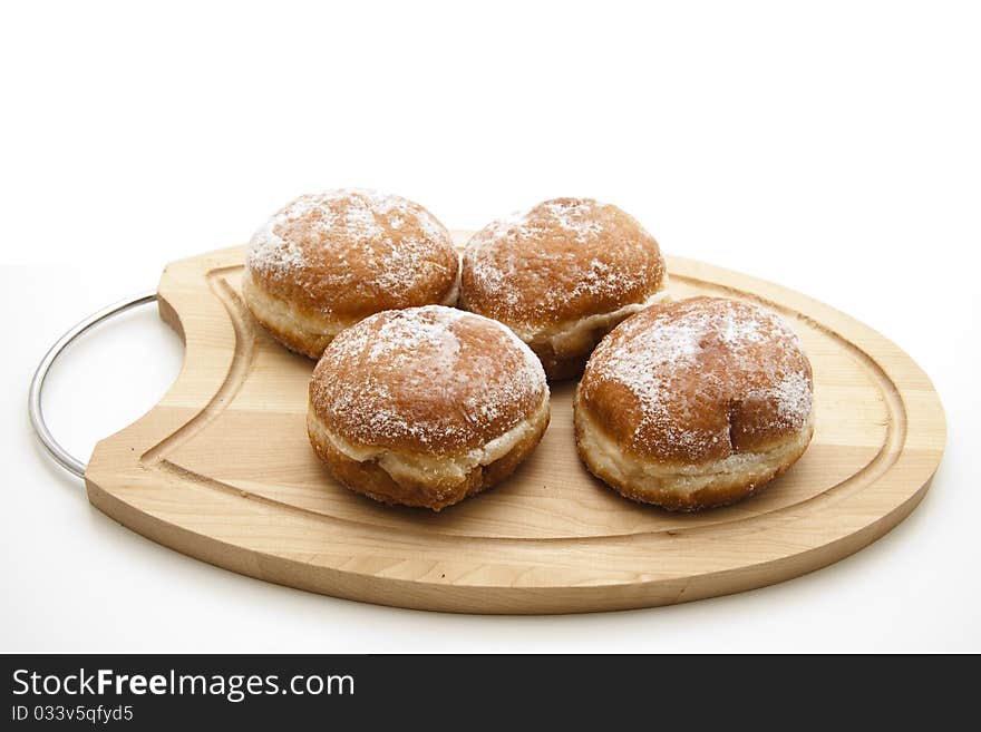 Filled donuts and onto wood plates. Filled donuts and onto wood plates