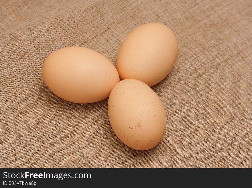 Chicken eggs on brown sacking