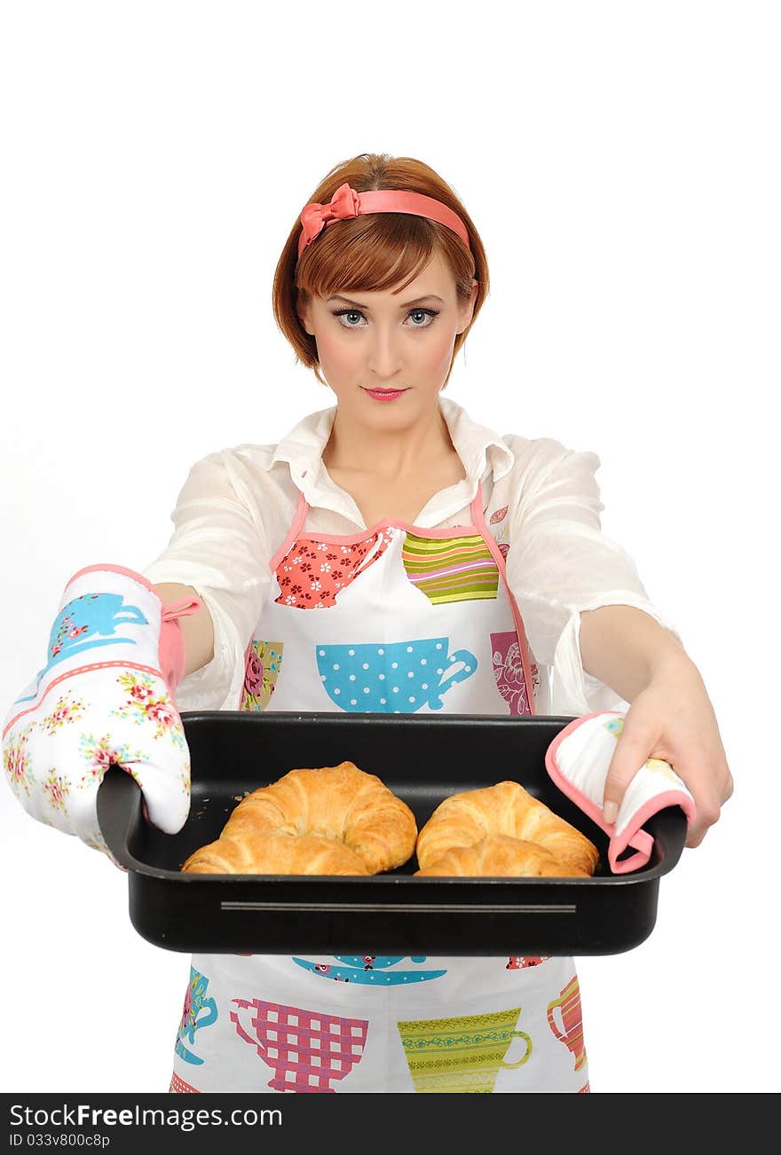 Beautiful cooking woman in apron eating fresh made croissant bread. isolated on white background. Beautiful cooking woman in apron eating fresh made croissant bread. isolated on white background