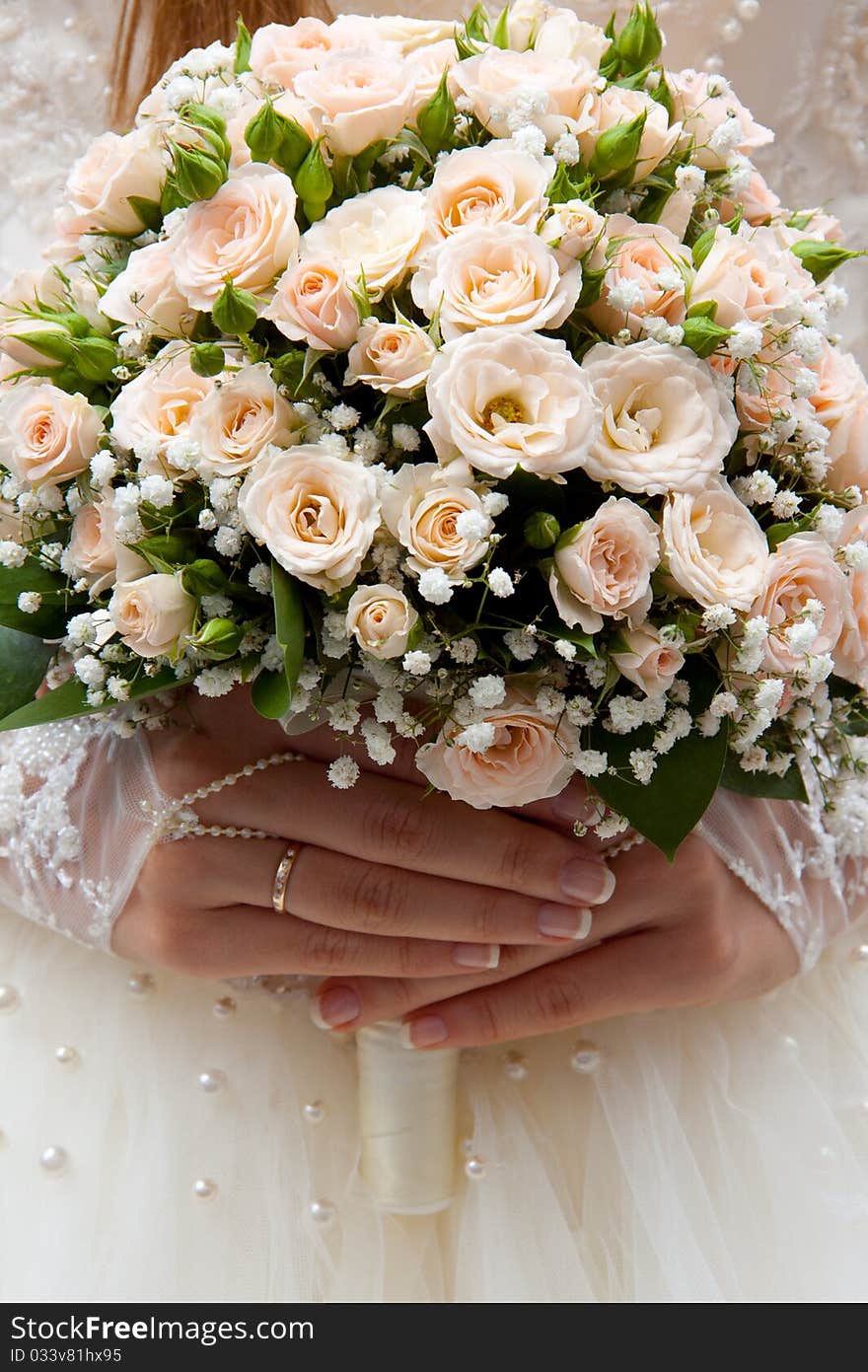 Bride holding wedding bouquet of roses in his hands