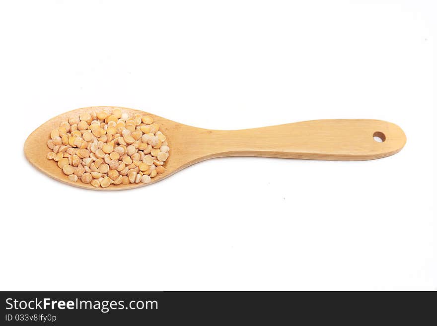 Yellow split peas on a wood spoon. Yellow split peas on a wood spoon