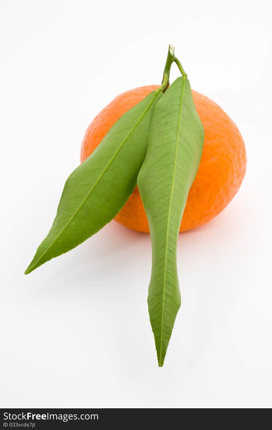 Mandarin orange with leaves isolated on a white background.