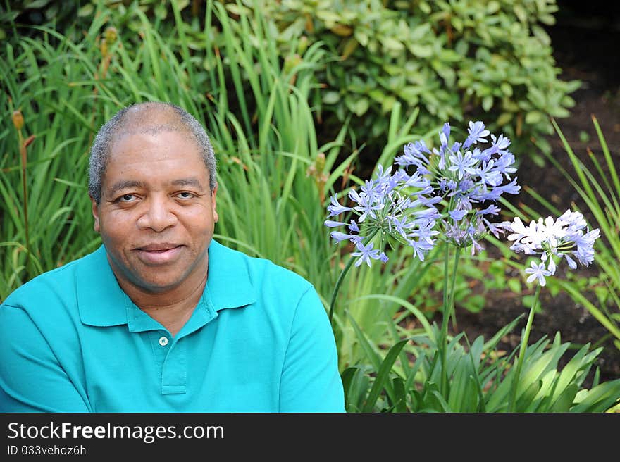 African american male relaxing outdoors in the woods. African american male relaxing outdoors in the woods.