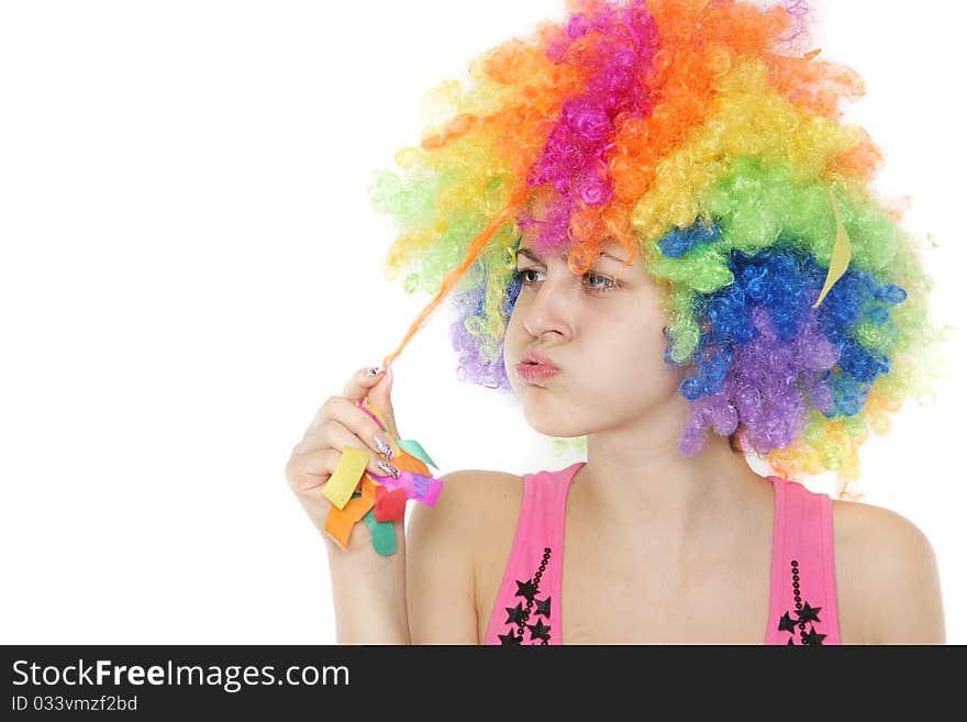 Young woman in colorful clownish wig over white