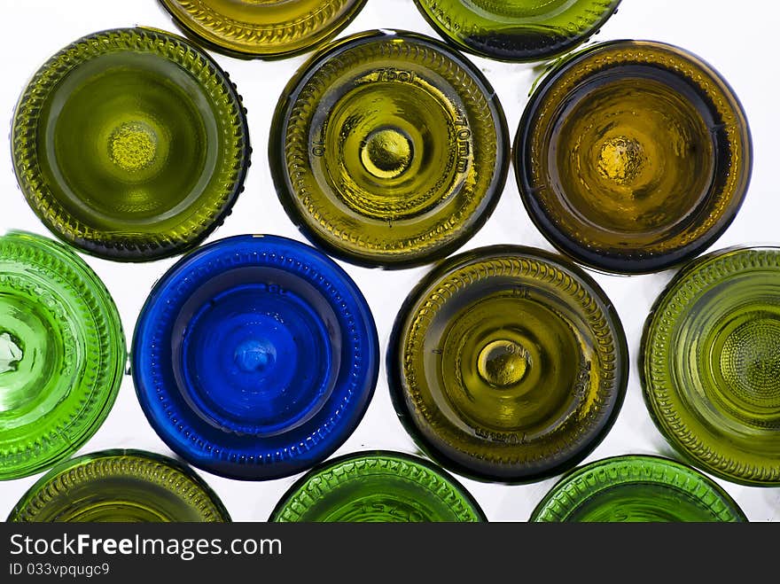 There are many varicoloured bottles on a white background