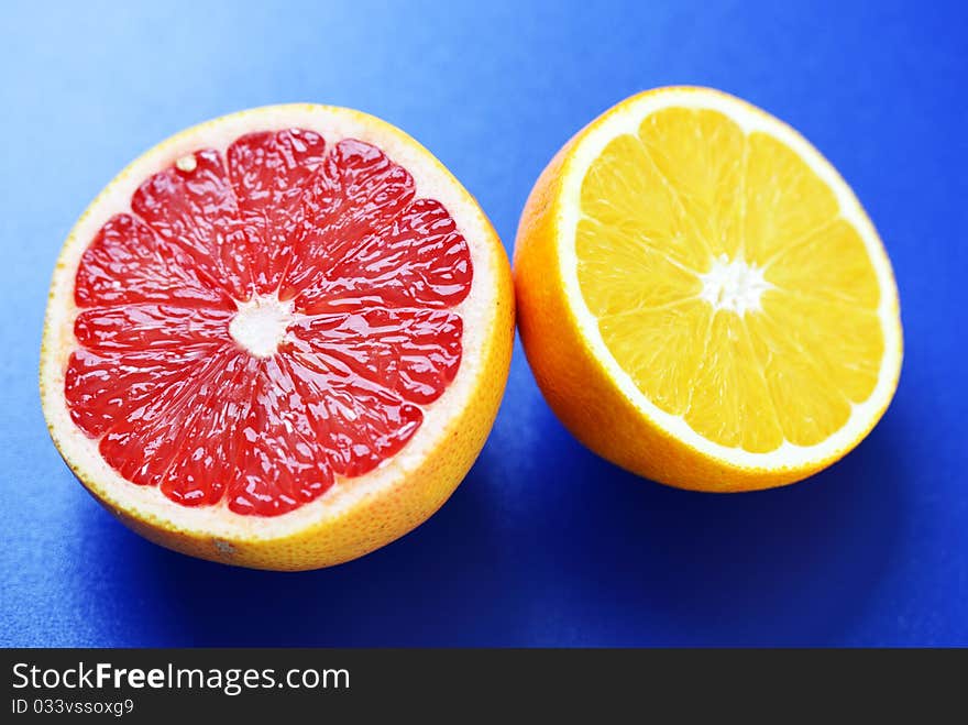 Grapefruit and oranges on a blue background