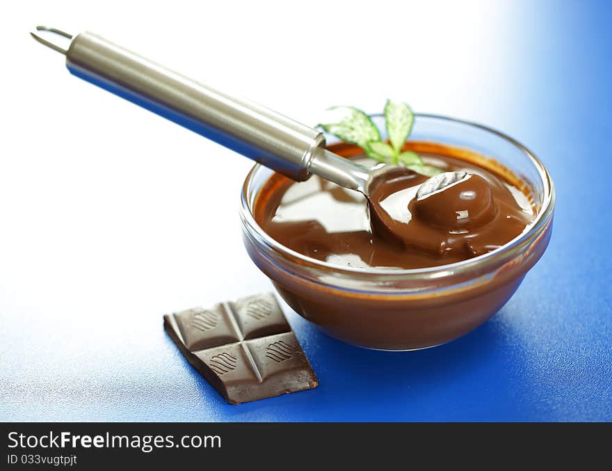 Hot chocolate in a transparent dish with a spoon